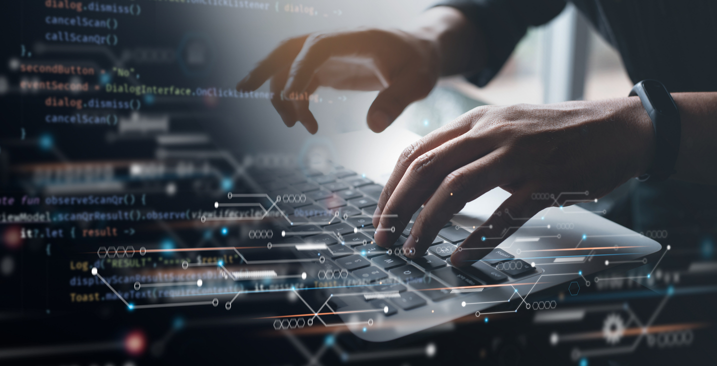 Close-up of hands typing on a laptop keyboard. The overlay shows lines of code and data points, suggesting software development or programming. The background is blurred, emphasizing the action on the keyboard.