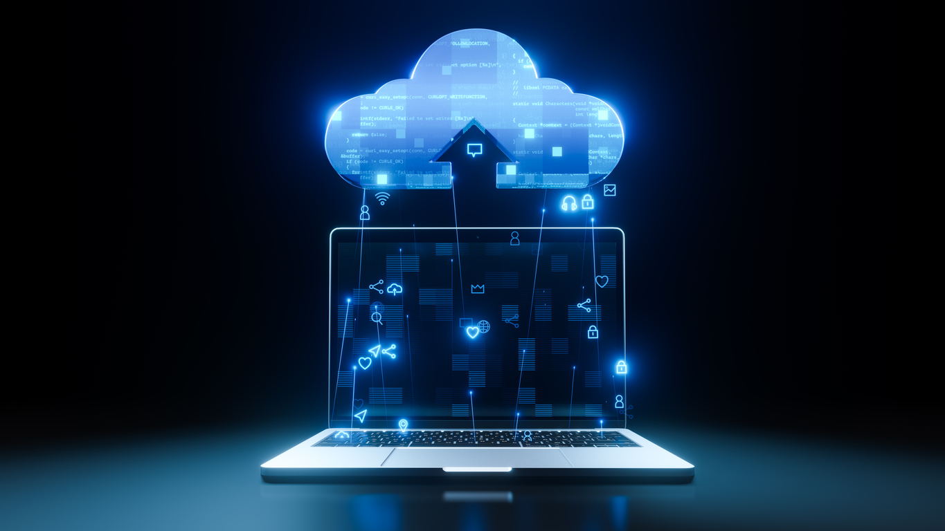 A glowing holographic cloud icon emerges from a laptop screen, symbolizing cloud computing. Various tech icons such as locks, chat bubbles, and gears connect to the cloud, indicating data storage, security, and communication. The background is dark.