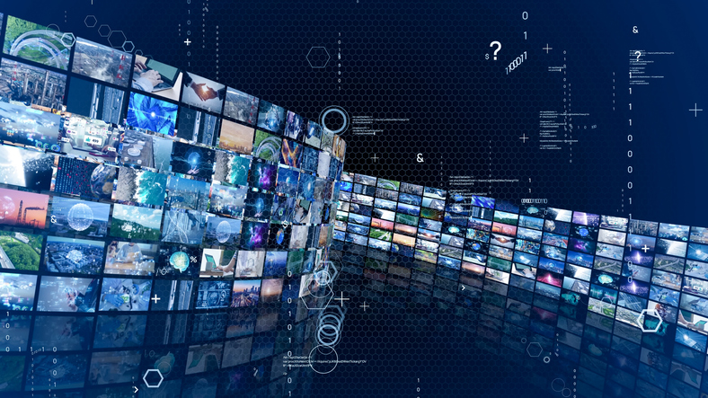 A curved wall of multiple digital screens displays various images and videos, depicted in a futuristic style. The background is dark blue with hexagonal patterns and floating symbols, giving a high-tech ambiance.